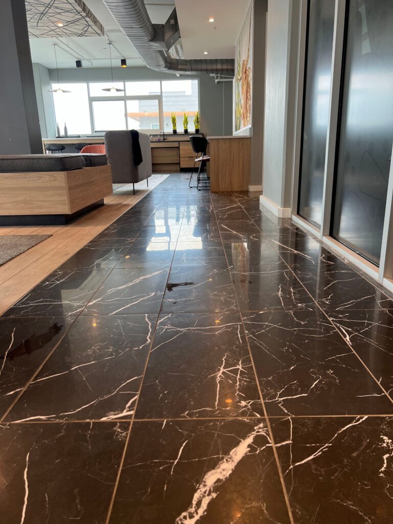 A black floor cleaned in a lobby of a business